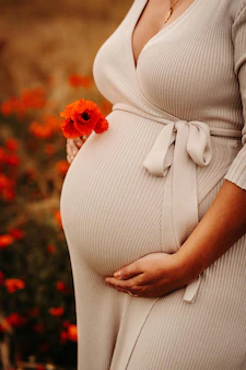 pregnant-female-standing-among-blooming-poppy-field_181624-59498